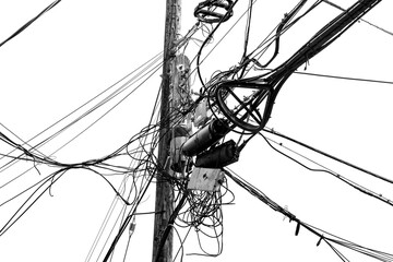 Wooden power pole with lots of cables and electrical devices on a street in the USA. Contrasting black and white photo of a tangle of wires and cables that are part of the city's utility network.
