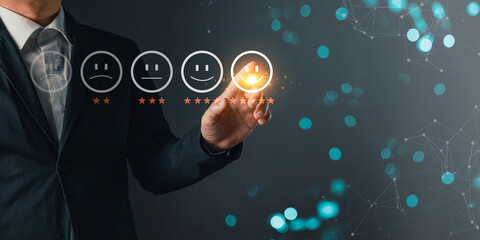 a businessman touching the virtual screen on the happy smile face icon to give satisfaction in service.rating very impressed.customer review service and Satisfaction concept