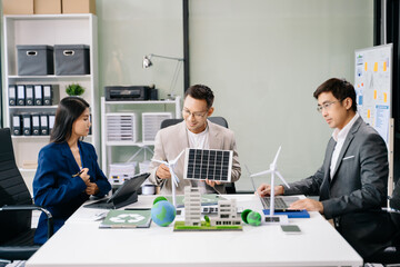 Business people having consultation about wind energy at company office. Business team discussing about windmill and alternative green enery. Net zero