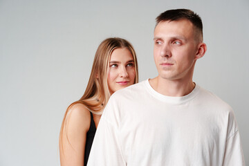 A Man and a Woman Standing Next to Each Other in studio