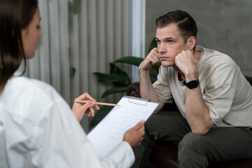 Stressed and depressed patient seeking help from psychiatrist with mental illness and depression in...