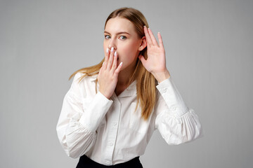 Woman in White Shirt Listening With Hand to Ear
