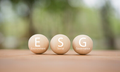 ESG on round wooden blocks. ESG concept for businesses and organizations, environment, society,...