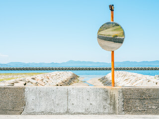 Dramatic view of a traffic mirror by the beach in summer, Teshima Island in Kagawa Prefecture in...