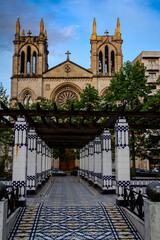 Pergola in the Begoña park and in the background the church of San Lorenzo from the late 19th century. Gijón, Asturias, Spain.