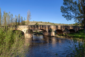 Fototapeta premium Panorama of the 18th century Montejo de la Vega de la Serrezuela bridge, seen upstream from the southern bank. Segovia, Castile and Leon, Spain.