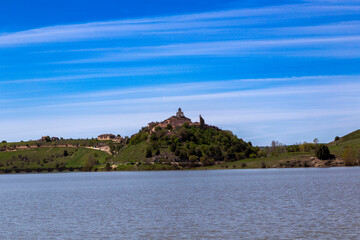 Fototapeta na wymiar Maderuelo in the background from the shore of the Linares reservoir. Segovia, Castile and Leon, Spain.