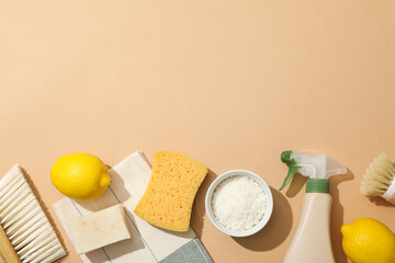 Towel, brushes, sponge and ingredients for natural detergent on beige background, space for text
