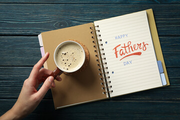 World father's day concept, with notebook on cup on blue background.