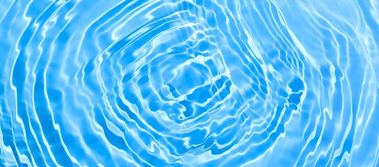 Abstract blue water ripple surface. Transparent clear water texture on blue background. Sunlight...