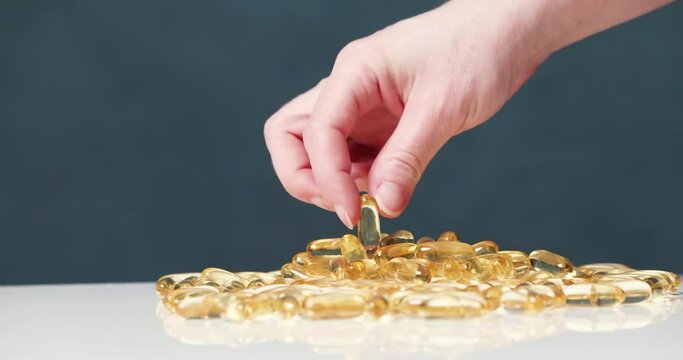 many pills lie on a white table on a dark background
