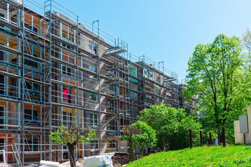 Modern residential apartment building under construction. Reconstruction of a building. Summer day.