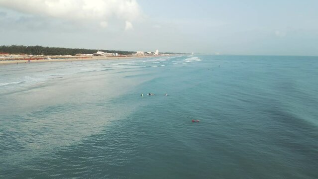 Surfers waiting for a wave at the magnificent Playa Miramar in Tampico, Mexico.