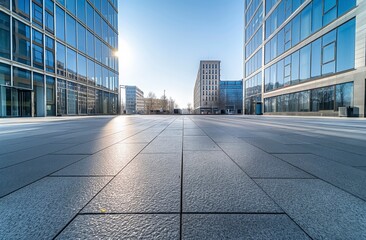 A large city street with a large business building in the background. The street is empty and the sky is clear