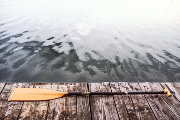 Paddle on wooden dock. Concept of canoeing as dynamic and adventurous sport