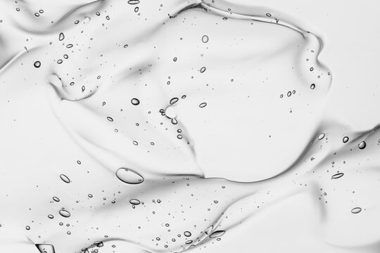 Hyaluronic acid serum texture. Beauty skin care liquid gel background. Clear cosmetic cream with bubbles closeup
