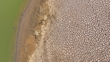 Behold, from the sky, a once-teeming lakebed now a haunting portrait of desiccation. Cracked earth...