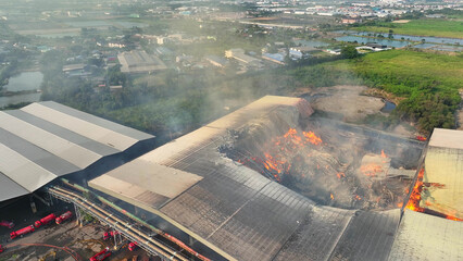 The industrial site lay in ruins, ravaged by a raging inferno. Roof sections collapsed, flames...
