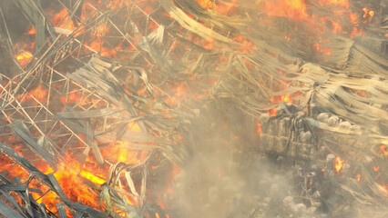 Amidst the industrial wreckage, flames dance recklessly, devouring layers of metal and debris....