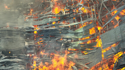 From above, witness the fierce blaze ravaging an industrial complex, consuming metal sheets and...