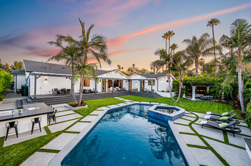 Backyard pool in a verdant garden setting in a modern new construction home in Los Angeles
