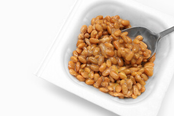 Close up of Natto or Fermented Soybean with stainless spoon isolated on white background. Traditional food in Japan. Ready to eat