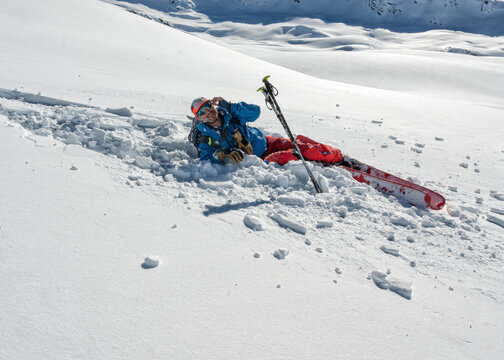 Fallen skier lying down in snow