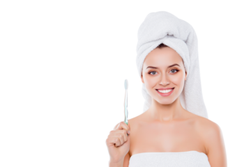 Portrait with copyspace of nice cute girl with beaming smile and turban on head holding toothbrush isolated on white background