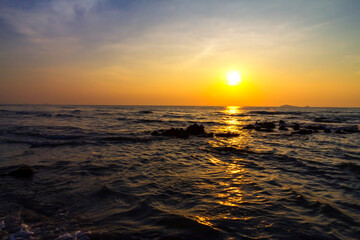 Sunrise on water in morning at beach