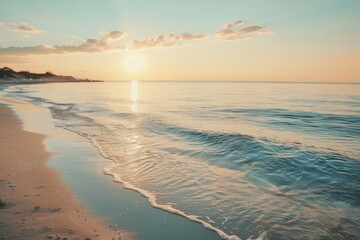 Fototapeta premium Sunset over calm sea with sandy shore