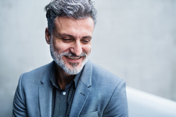 Handsome businessman in modern office space, portrait, headshot.