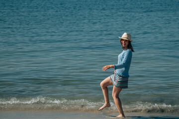 young woman having fun on the beach shore