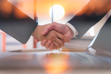 Businessmen handshaking with partner greeting dealing for business, finance and investment background, teamwork and successful business  joint venture concept with sunrise background