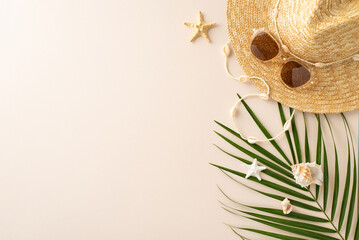 Embrace the sun-kissed feels: top view of straw hat, sunglasses, island necklace, palm leaves, shells, and starfishes on pastel beige, setting the mood for summer-inspired posts