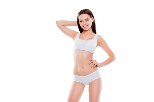 Portrait of fit slender woman with perfect body in white cotton underwear bikini posing looking at camera isolated on white background
