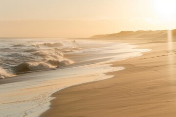 Peaceful misty beach at sunrise with gentle waves