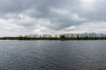 waves on the surface of the river in cloudy spring weather