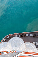 Top view of sea and water of sailing ship. Lounge promenade deck on cruise liner, vertical photo. 