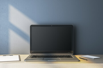 Fototapeta premium Close up of empty computer monitor on simple wooden desk. Blue wall background. Workplace concept. Mock up, 3D Rendering.