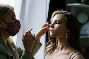 Make-up artist work in her studio with model