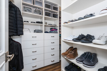 Wardrobe packed with various garments and shoes in a new construction home in Encino, California