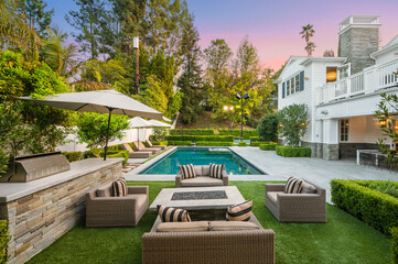 Poolside patio with outdoor dining table in a new construction home in Encino, California