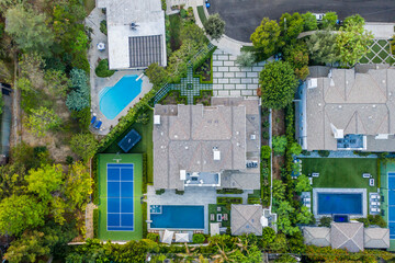 Aerial view of houses and tennis courts in a residential area in Encino, California