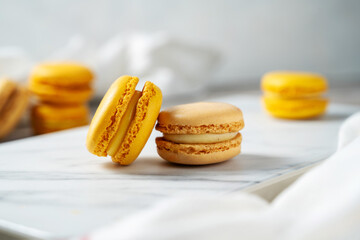 Colorful yellow Macrons closeup. Sweet dessert, sugar