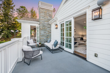 Balcony with a sofa, chairs, and an open door  in a new construction home in Encino, California