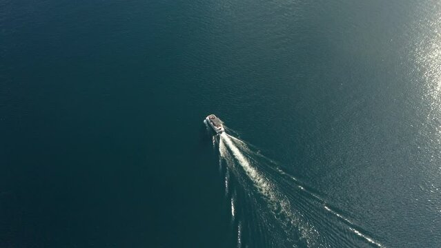 Drone tracking footage of a boat riding in redfish lake surrounded by blue water