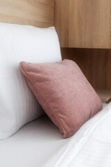 Pink and white soft pillows on the bed