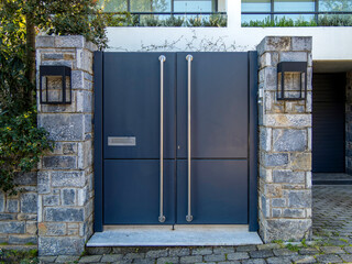 A contemporary design house entrance with a plain iron door at posh suburbs of Athens. Travel in...