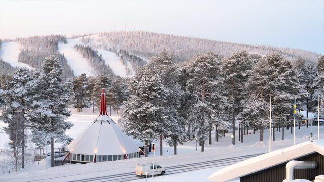 Snow-Covered Roof Of Swedish Restaurant On Wintery Landscape Of Arvidsjaur In Sweden. wide shot