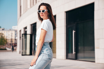 Young beautiful smiling hipster woman in trendy summer white t-shirt and jeans clothes. Sexy...